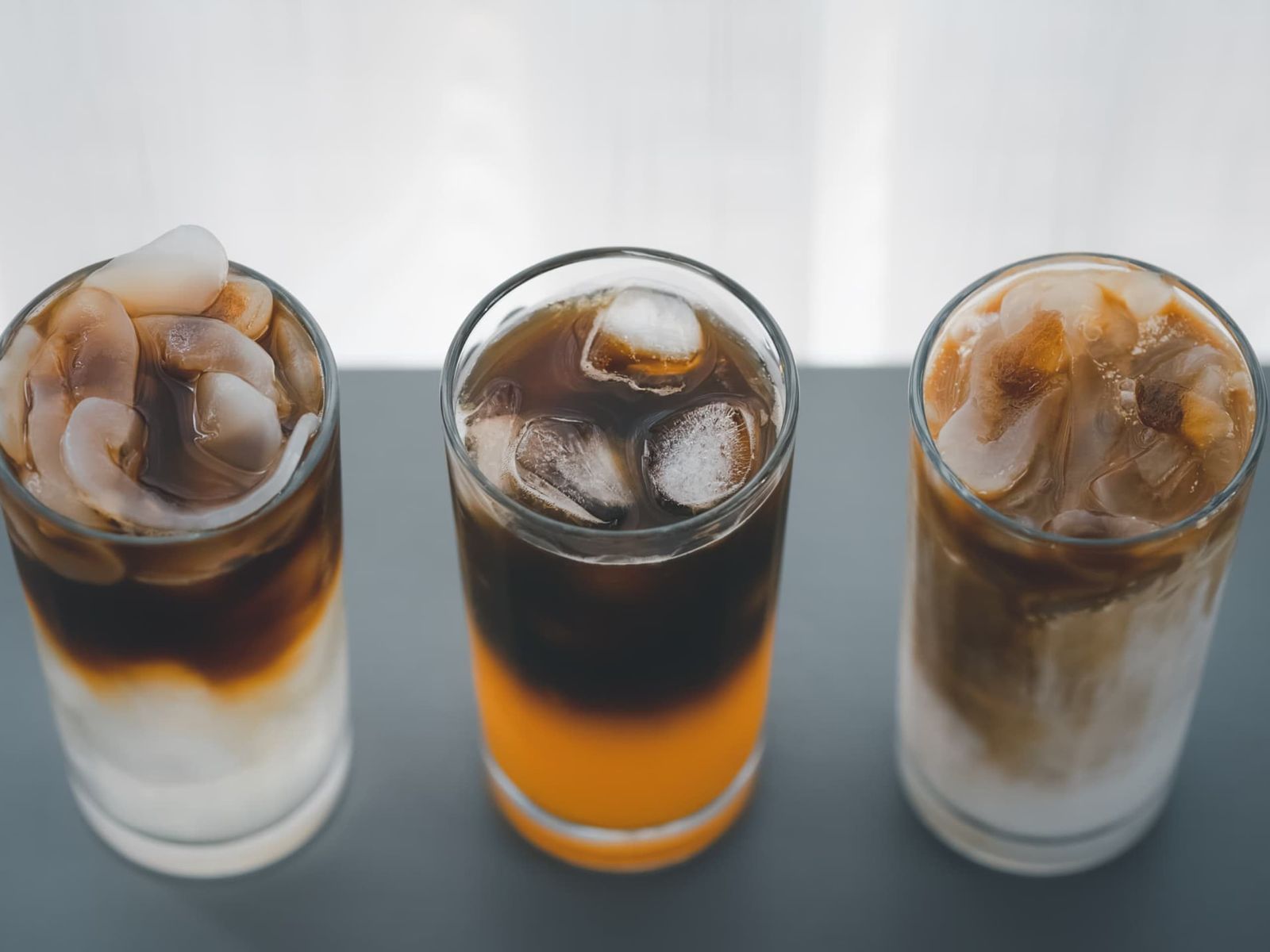 different iced coffee with toddy palm, orange, and coconut milk
